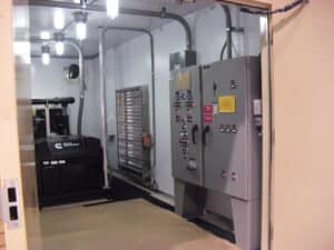 Generator and control panel shot inside building