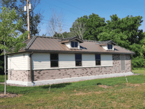 AquaPak building installed. Has faux windows, dormers,and half brick siding.