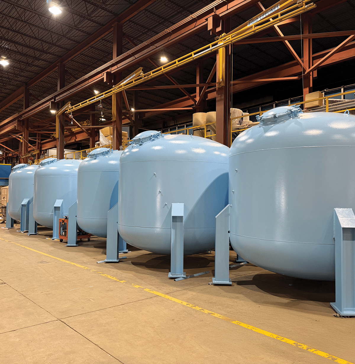Pressure Vessels Blue pressure vessels in a line on the factory floor.