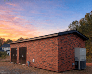 An installed water booster modular building. The building has a red mixed brick exterior.