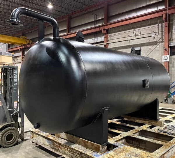 Expansion Tank Black expansion tank sitting in the factory.