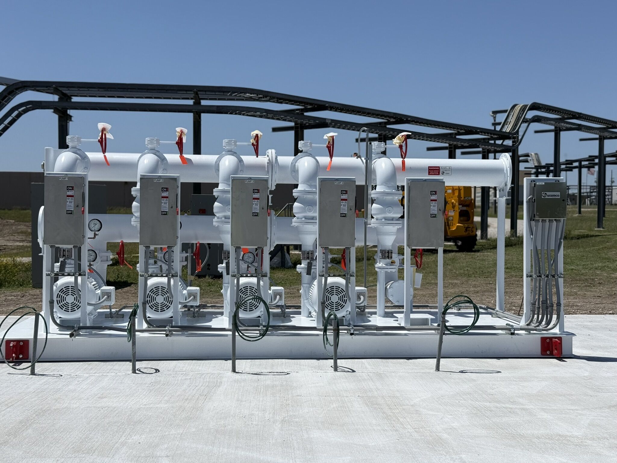 USEMCO Booster SkidPak USEMCO booster SkidPak with blue pumps installed on the job site